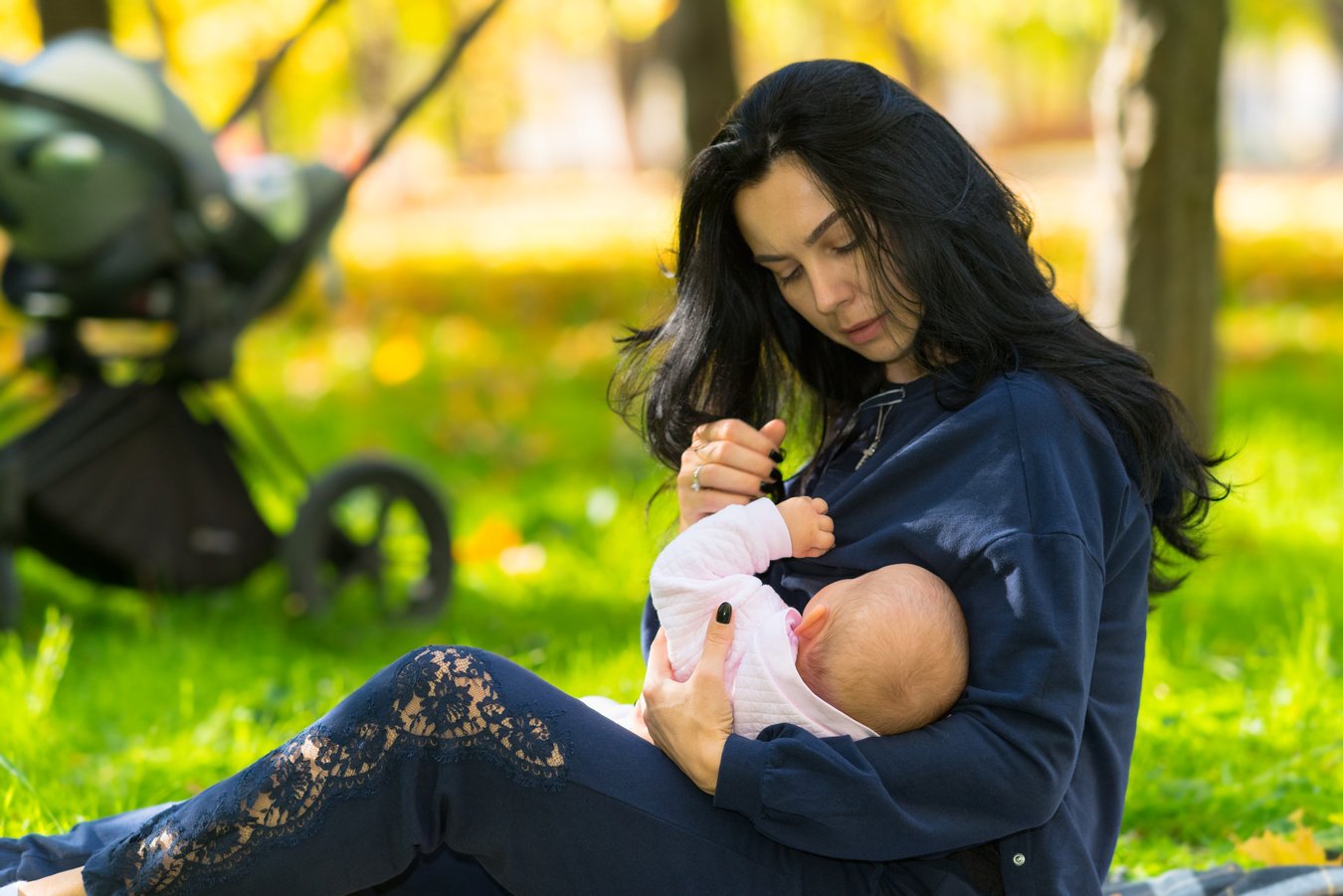 Mother discreetly breastfeeding baby outdoors